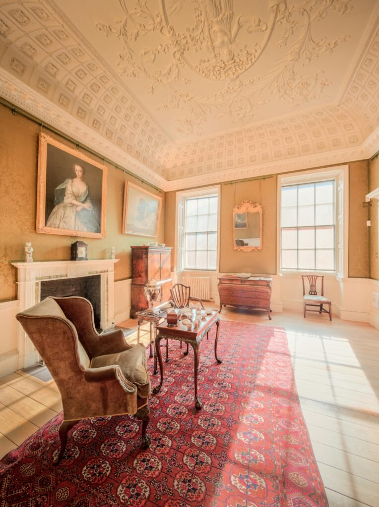 Sunlit historical room with classic decor and elegant furnishings in a vintage English house.
